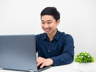 Man working with his laptop feeling happy and smile at the table work from home concept