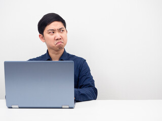 Man using laptop on the table not satisfied looking at copy space white background