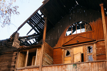 Old wooden two-storey house without windows after a fire