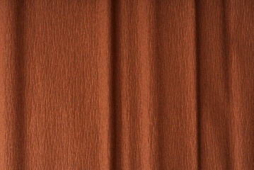 Fototapeta premium Texture of dark brown paper folded in waves a little closer
