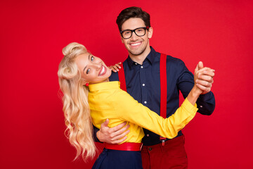 Photo of beautiful sweet young guy lady wear pin up clothes dancing twist smiling isolated red...