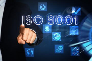 Man pointing at virtual screen with text ISO 9001 and different icons, closeup