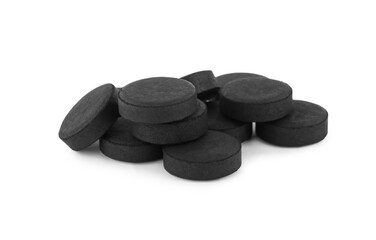 Activated charcoal pills on white background. Potent sorbent