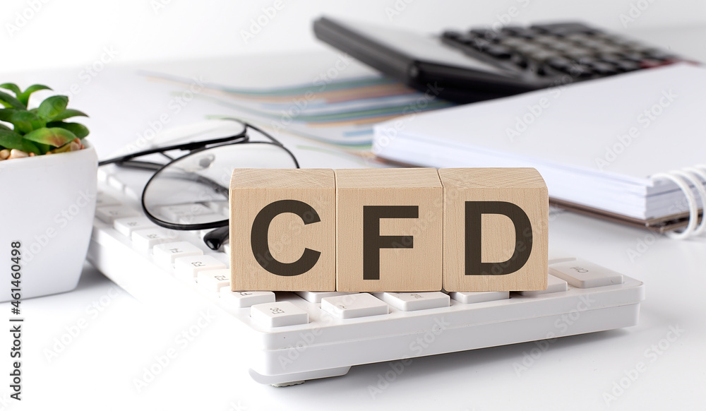 Poster cfd written on a wooden cube on keyboard with office tools