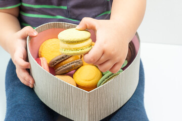 almond cookies in the hands of the toddler. Close