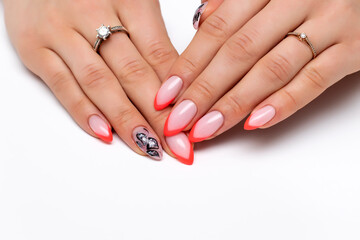Orange french manicure with painted flowers on long oval nails close-up on a white background