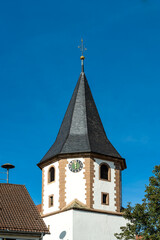 Kirchturm der evangelischen Marienkirche in Botenheim, einem Stadtteil der Heuss-Stadt Brackenheim im Landkreis Heilbronn im nördlichen Baden-Württemberg mit blauem Himmel.