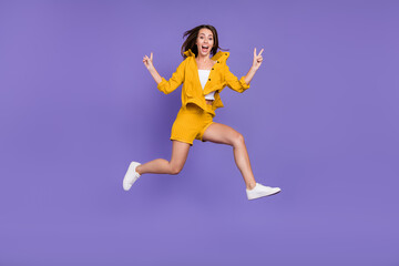 Full size photo of amazed stylish trendy brunette haired woman v-signs jump isolated on purple color background