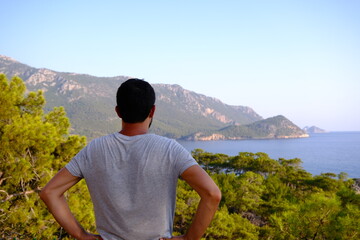 man watching sea and forest view