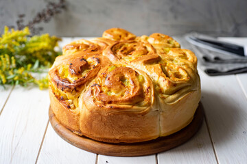 Delicious dessert: yeast pie with vegetable filling on a wooden platter. Close-up