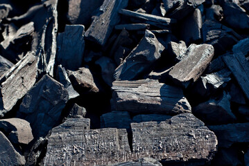 Coal from burned firewood. Heat in the grill. Coal texture close up.