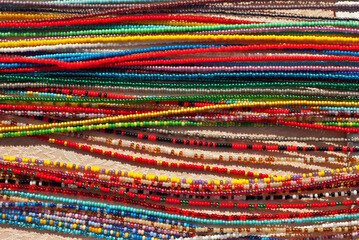 Necklace of colorful stones on the table. Many different jewelry and beads made of natural precious minerals. Beaded jewelry is on sale at the fair.