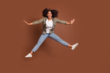 Fototapeta na wymiar Full body portrait of overjoyed satisfied childish person toothy smile isolated on brown color background
