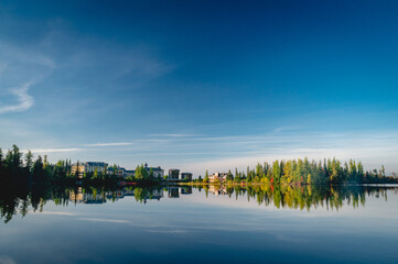 Autumn forest reflected in water. Colorful autumn morning in the mountains. Colourful autumn morning in mountain lake. Colorful autumn landscape. Autumn in Canada