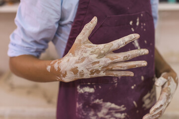 Female pottery artist hands . Ceramic art studio.Close Up view . Creative handmade