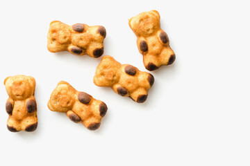 Wings on a plate. Dessert in the form of bears. Cookies on a white background. 