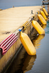 Berth without a boat with yellow protective buoys.