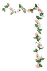 Detailed shot of the long artificial branch with pink roses. Branch has many green leaves. Artificial decor is isolated on the white background.