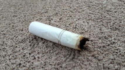 cigarette stub on the ground
