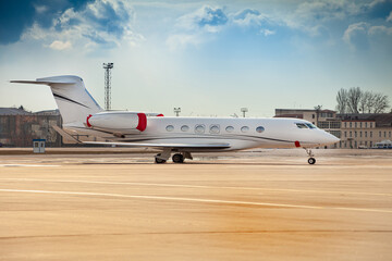 Small white plane at the airport. Runway. Charter flight. Flight on a journey. Fly in a private...