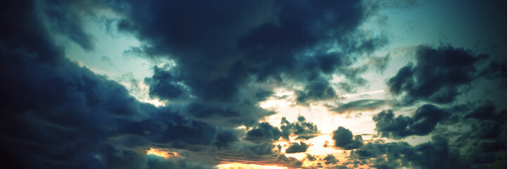 Dramatic sunset sky with clouds.