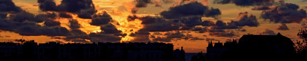 Dramatic sunset sky with clouds.
