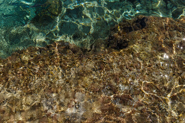 Sea waves on the wild rocky coast. Beautiful seascape. Travel concept. Seascape on the background of the wild rocky coast. Wild beach, azure water and rocks. Mediterranean sea, Cyprus. Postcard view