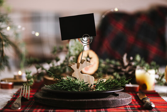 Reindeer of wood with blank name card in christmas table