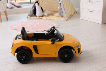 Yellow car in room at home. Child's toy