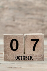 cube calendar for october on wooden background with copy space