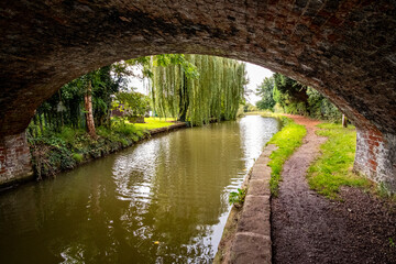 Fototapeta na wymiar Trent and Mersey canal with arch bridge in Cheshire UK