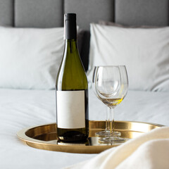bottle of wine and glasses in the bed