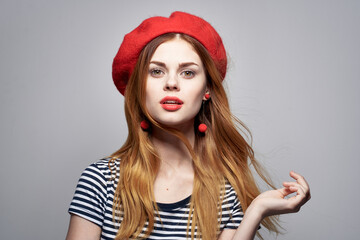 pretty woman wearing a red hat makeup France Europe fashion posing light background