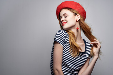 Naklejka premium beautiful woman wearing a red hat makeup France Europe fashion posing model studio