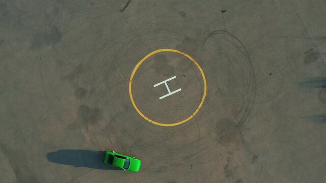 Ariel Overhead Shot Drift Sports Car In A Circle. Ariel Overhead Shot Drift Sports Car In A Circle. Helipad