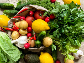 Concept of Organic vegetables grocery shopping. Variety of fresh vegetables from farmers market on craft paper.Fresh vegan and vegetarian food delivery. Season of harvest.Colourful photo for food blog