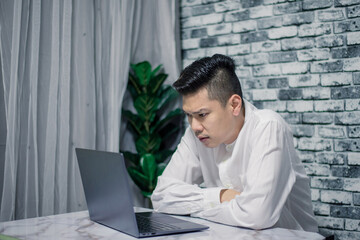 Portrait of young man businessman working  at  office with laptop on desk