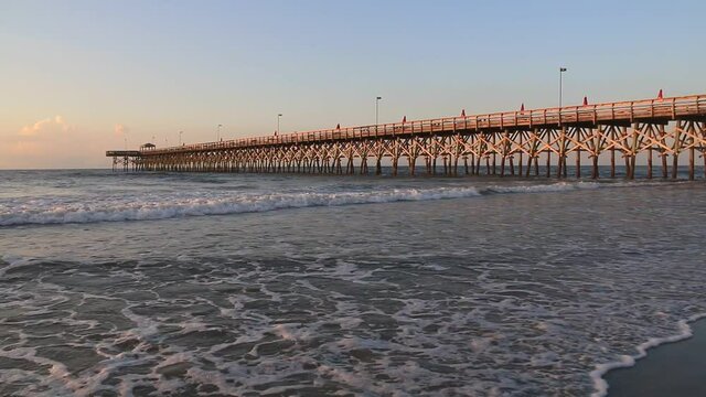 summer sunrise on the beach front near the pier of Myrtle Beach in South Carolina.
