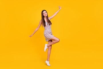 Fototapeta na wymiar Full length body size confident girl in dress smiling overjoyed careless isolated vivid yellow color background