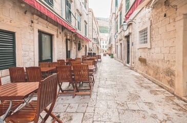 Travel to Croatia. Dubrovnik old town and harbor with narrow stone stairway leads to the old town in Dubrovnik, Croatia, with its well-preserved stone walls that seem to touch the clear blue sky