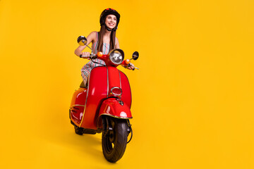 Full length body size photo smiling girl riding motorbike looking blank space isolated vivid yellow color background