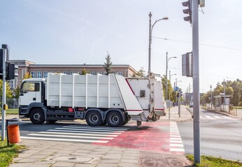 garbage truck at the intersection of the city road