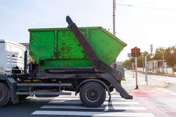 garbage truck at the intersection of the city road