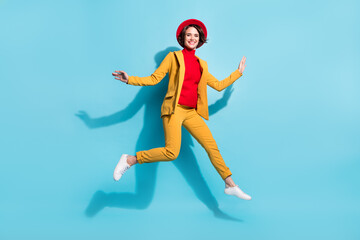 Fototapeta na wymiar Full length body size view of attractive cheerful pretty girl jumping having fun isolated over bright blue color background