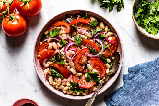 A piyaz salad, a traditional Turkish White Bean Salad PIyaz. Served in a ceramic bowl.