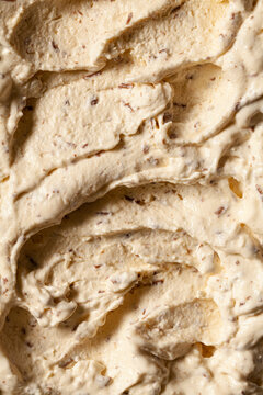 A close up of coconut icecream with desiccated coconut and grated chocolate stirred through