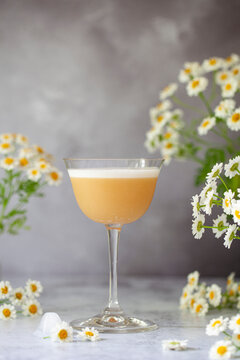 Amaretto Sour cocktail with flowers