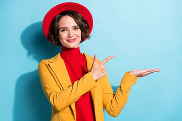 Photo of young girl happy positive smile point finger empty space ad advise choice offer isolated over blue color background