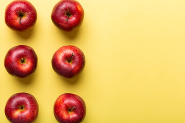 Many red apples on colored background, top view. Autumn pattern with fresh apple above view with copy space for design or text