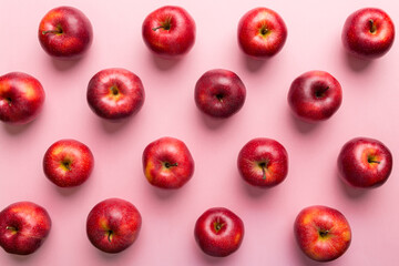 Many red apples on colored background, top view. Autumn pattern with fresh apple above view